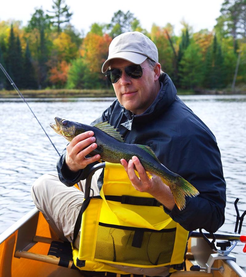 happy-fisherman-holds-up-a-walleye-on-a-northern-m-DN2SM64-resize.jpg